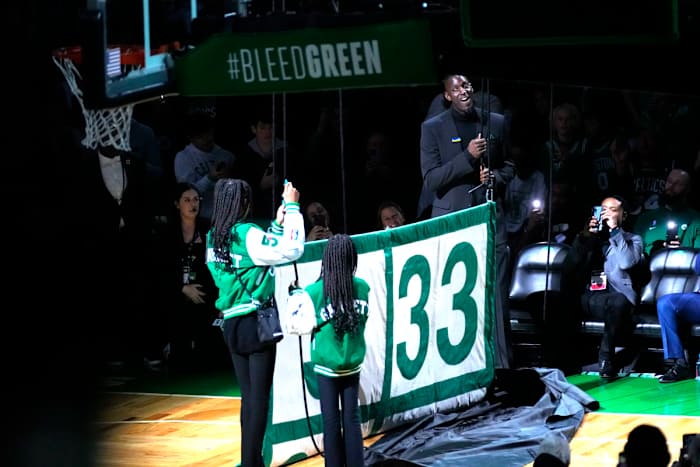Former Boston Celtic and Basketball Hall of Famer, Kevin Garnett along with his daughters help raise his number 5 to the rafters along with the other retired players numbers after the game between the Boston Celtics and Dallas Mavericks at TD Garden.